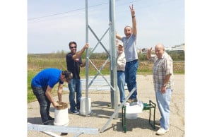 Rick Dirck (second from right) and other WSCA volunteers assemble the station’s new radio tower in May. The tower will soon be erected in Newington, expanding the station’s reach.