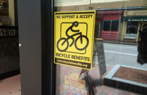 A Bicycle Benefits sticker on a storefront in downtown Portsmouth, NH.